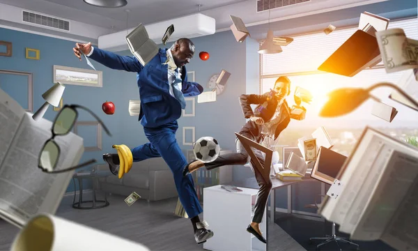 Black businessman in a suit playing footbal — Stock Photo, Image