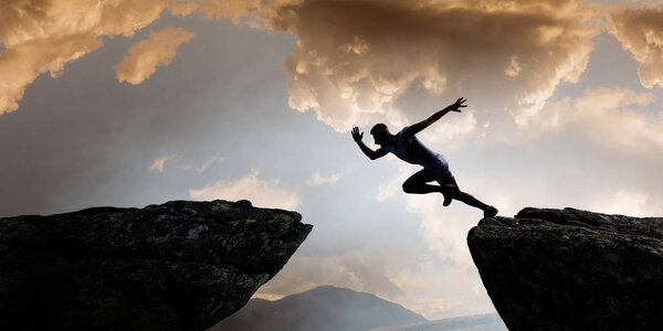 Jumping over precipice, challenge concept.