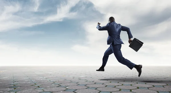 Running black businessman with briefcase isolated