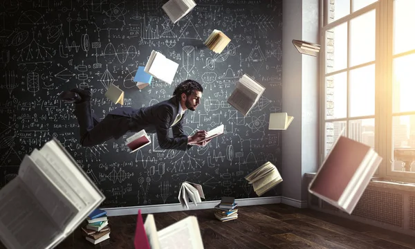 Man flies and works on laptop. Mixed media — Stock Photo, Image