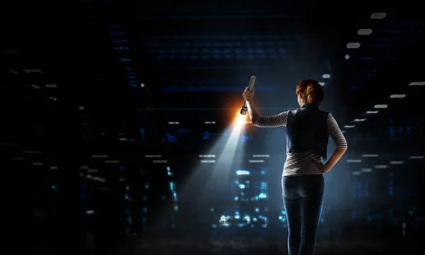 Young woman holding a flashlight — Stock Photo, Image
