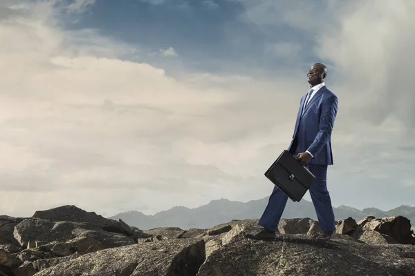 Black joyful businessman with briefcase — Stock Photo, Image