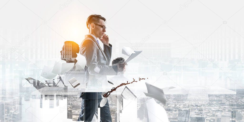 serious businessman with glasses, making a phone call and looking at documents