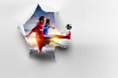 Çocuk futbolcu beyaz kağıtları kırıyor. Karışık ortam
