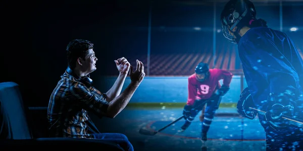Young man watching ice hockey game on TV — Stock Photo, Image