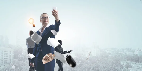 Businesswoman standing against cityscape and making selfie — Stock Photo, Image