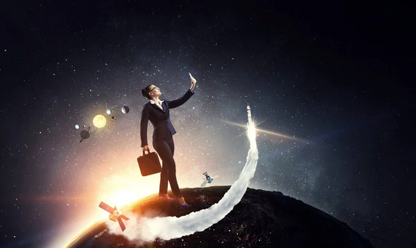 Businesswoman standing against space landscape and making selfie — Stock Photo, Image