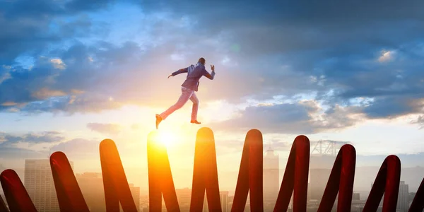 Un hombre de negocios saltando sobre un trampolín. Medios mixtos —  Fotos de Stock