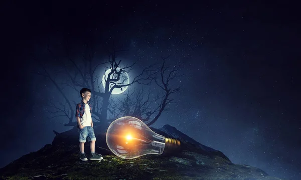Boy holding a light bulb — Stock Photo, Image