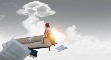 Kız oturuyor ve maceraların hayalini kuruyor.