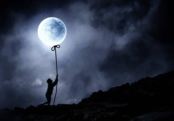 Kid girl catching moon . Mixed media — Stock Photo, Image