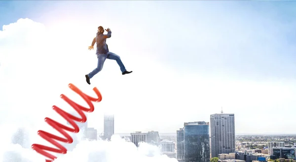 Un hombre de negocios saltando sobre un trampolín. Medios mixtos —  Fotos de Stock