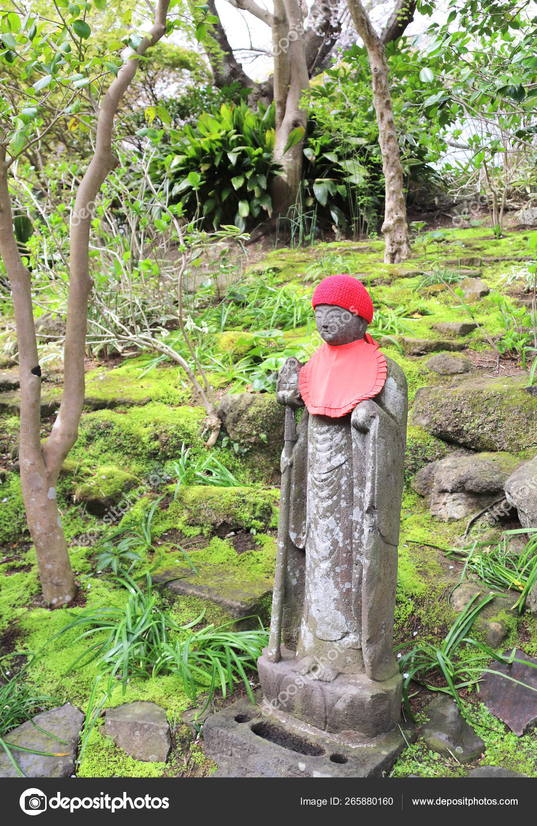 Stone statue of Jizo in a knitted hat, Miyajima, Japan Stock Photo by