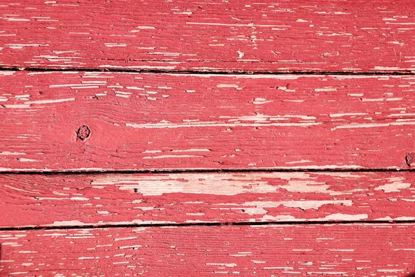 Ancient wood with cracked paint of red color — Stock Photo, Image