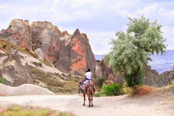 Tourists ride a camel, Pasabag Valley, Cappadocia, Turkey — Stock Photo, Image