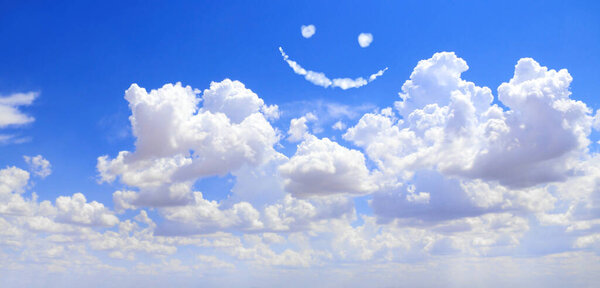 Happy concept. Smilie from white cloud in the blue sky 