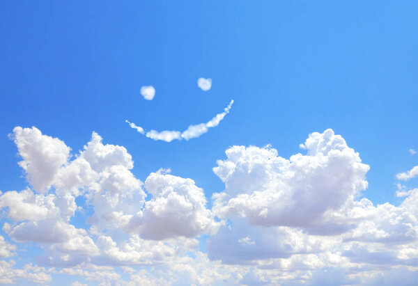 Happy concept. Smilie from white cloud in the blue sky 