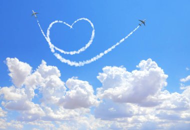 Two aircrafts draw a heart in the sky. Flight route of aircraft in shape of a heart. Love concept for traveling the world clipart