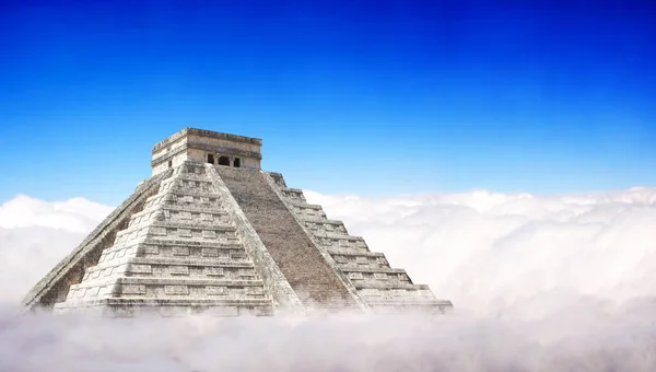 Giant Mayan Pyramid with a base hidden in the clouds. Horizontal banner with ancient pyramid of maya (Kukulcan Temple), Chichen Itza, Yucatan, Mexico. UNESCO world heritage site. Copy space for text