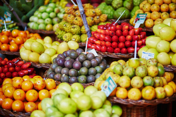 Many fresh and ripe exotic fruits on traditional farmer market Mercado dos Lavradores, Funchal, Madeira island, Portugal