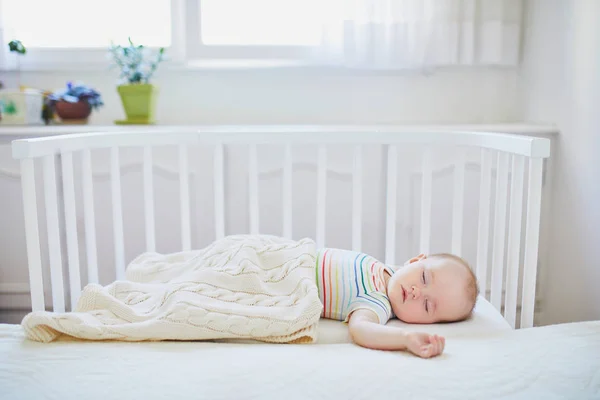 親のベッドに付属の共同寝台ベビーベッドで寝ている愛らしい赤ちゃんの女の子 小さな子供がベッドで一日昼寝をしている 日当たりの良い保育園の幼児 — ストック写真