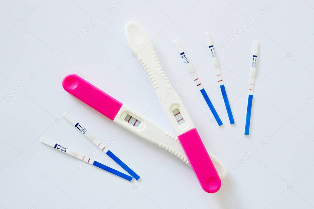 Many positive pregnancy tests. Fertility, pregnancy and maternity concept