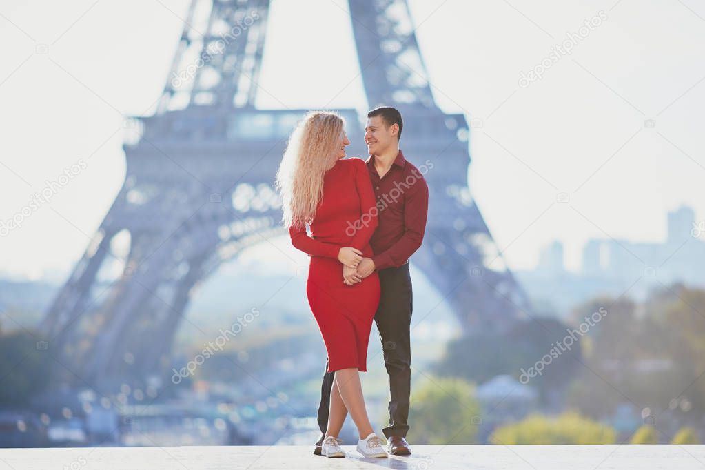 Romantic couple in love near the Eiffel tower in Paris, France