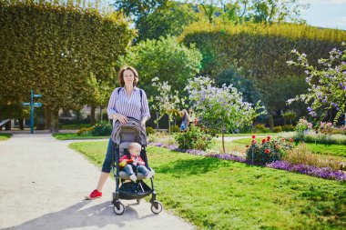 Mutlu genç kadın ile onun küçük kız Bebek arabasındaki bebek