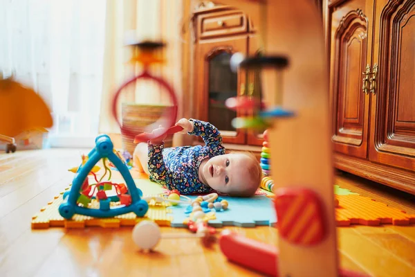 Baby meisje spelen met speelgoed op de vloer — Stockfoto