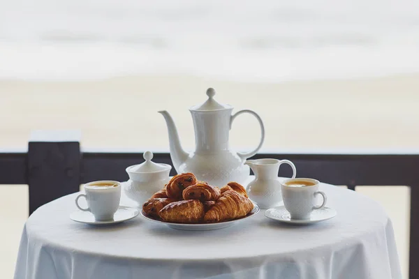 Two cups of coffee and traditional French pastry in cafe or restaraunt — Stock Photo, Image
