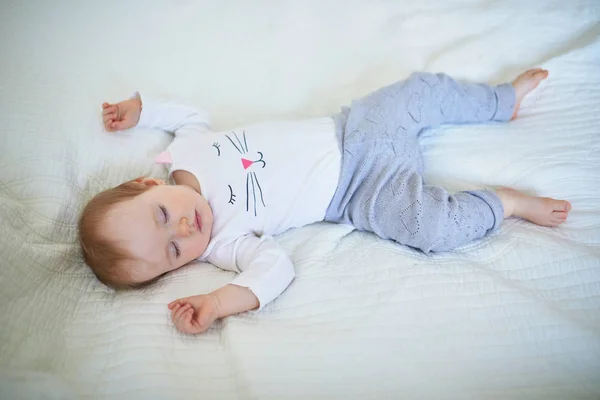 Adorable baby girl sleeping in crib — Stock Photo, Image