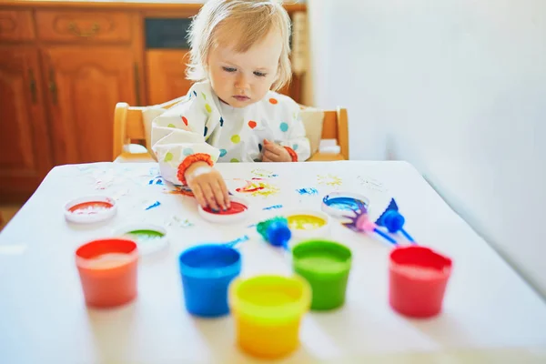 Adorable little girl painting with fingers — Stock Photo, Image