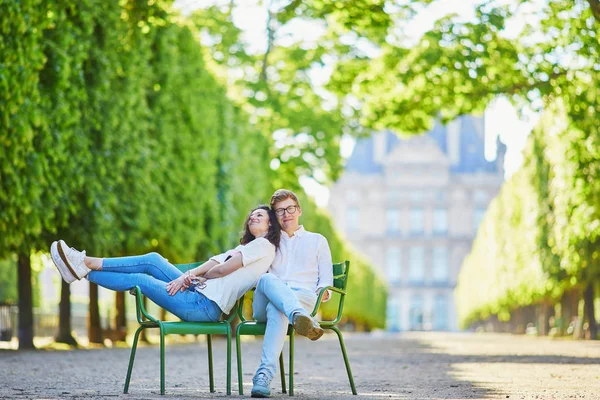 Happy romantic couple in Paris, sitting on traditional green metal chairs in Tuileries garden — Stock Photo, Image