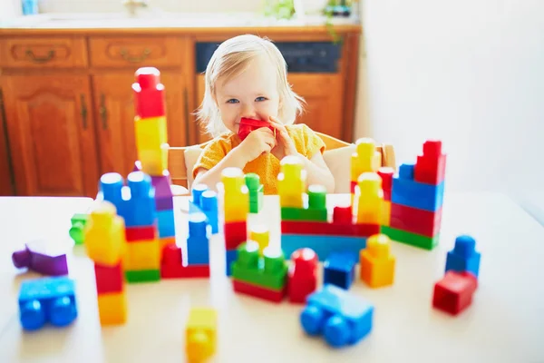 Niña jugando con bloques de construcción de plástico de colores — Foto de Stock