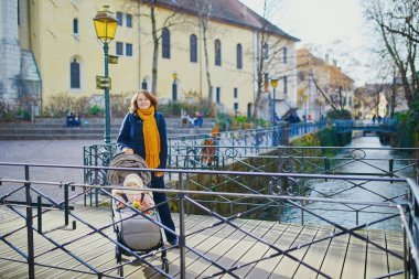 Mutlu genç kadın ile onun küçük kız Bebek arabasındaki bebek