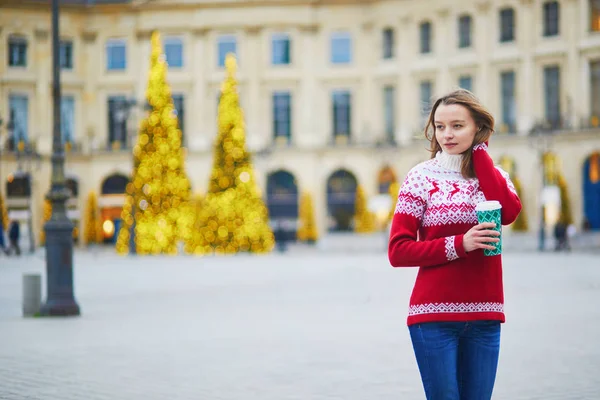 Girl walking with hot drink to go on a street of Paris decorated for Christmas — Stock Photo, Image