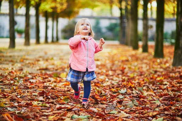 Adorable niña alegre corriendo en el jardín de las Tullerías en París, Francia —  Fotos de Stock