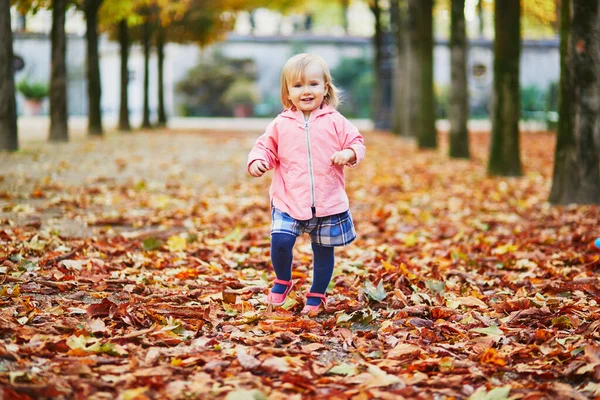 Adorable cheerful toddler girl running in Tuileries garden in Paris, France — Stock Photo, Image