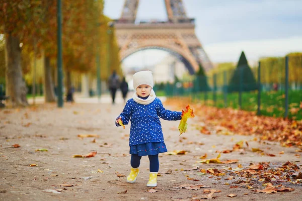 Adorable Toddler Girl Blue Raincoat Gathering Yellow Fallen Leaves Eiffel — Stock Photo, Image