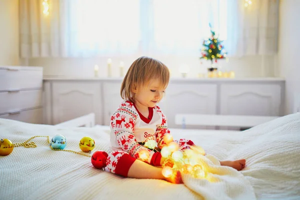 Happy Little Toddler Girl Wearing Pajamas Playing Christmas Decorations Bed — Stock Photo, Image