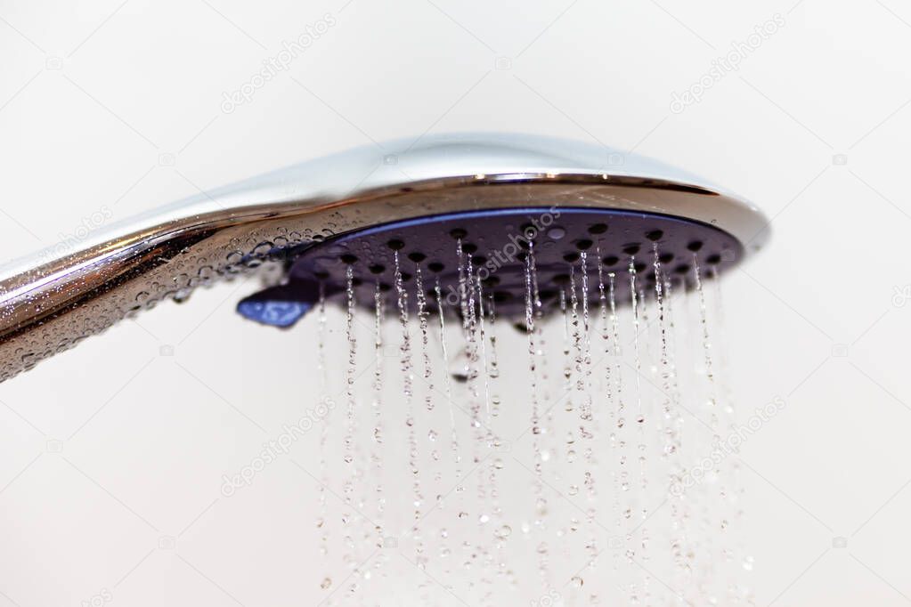 Head of shower with flowing water.