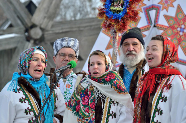 Chernivtsi,Bukovyna,Ukraine - January 13, 2019: Folklore collective perfoms ethnic singing during the festival of Christmas Carols in open-air museum of folk architecture.Singers are dressed in national clothes