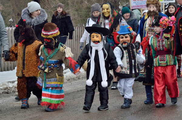 Vashkivtsi,Bukovina,Ukraine - January 14, 2019: Children  dressed as various personages including Jew, Bear and Malanka walking at traditional Pereberia (means change clothes) carnival.Its a festival held on Old New Years Day and Malanka holiday 