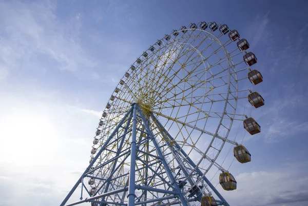 Ferris Wheel Over Blue Sky. Ferris wheel joy sky clouds. Park
