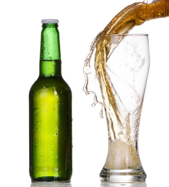 Pouring beer from bottle isolated on white background — Stock Photo, Image