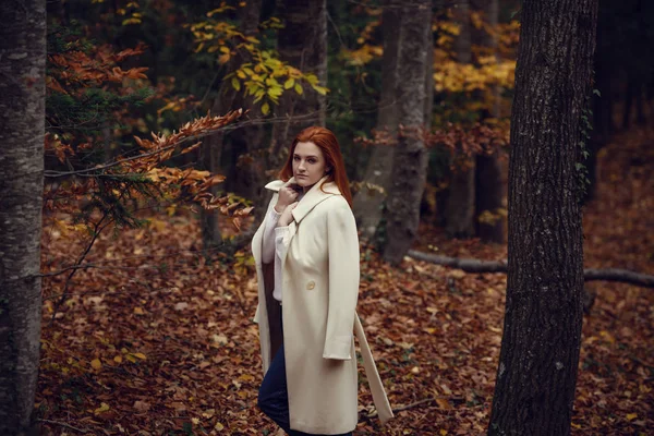 Beyaz önlük sonbaharda kırmızı saçlı güzel, romantik ve hüzünlü kız portresi.