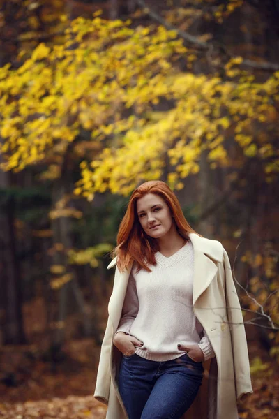 一个美丽的 梦幻般的和悲伤的女孩的肖像在白色大衣秋天的红色头发 — 图库照片