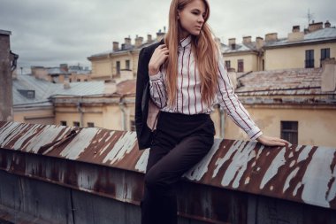 İş takım elbiseli kızıl saçlı bir kız güzel bir eski şehir yürüyor. St.Petersburg