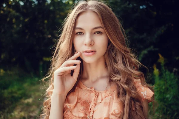 Fiatal nő, háttérben a nyári zöld park, zöld levelek. Futó lány gyönyörű göndör haja — Stock Fotó