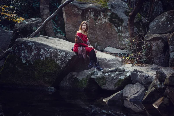 Menina bonita em um vestido vermelho caminha ao longo do parque da primavera — Fotografia de Stock